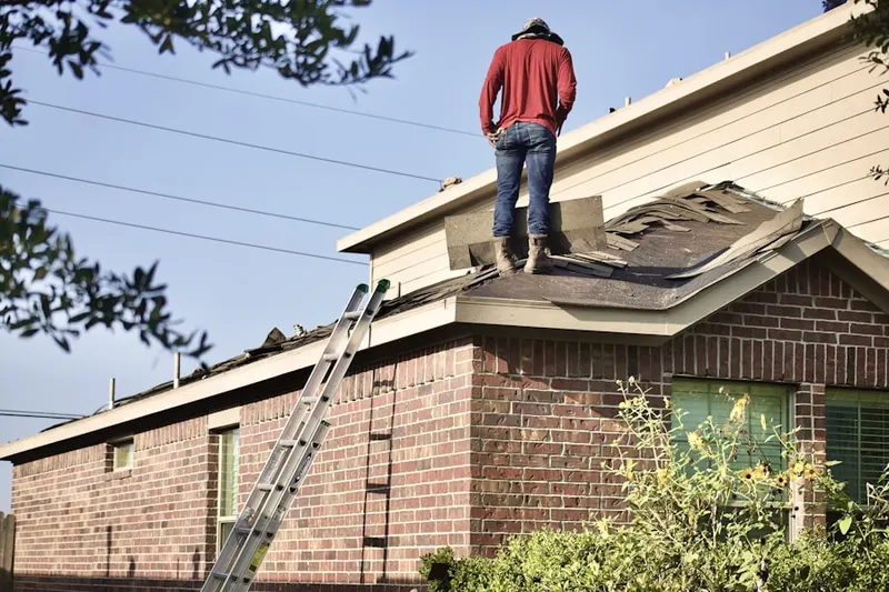 Professional roofer working on a residential roof in Suitland